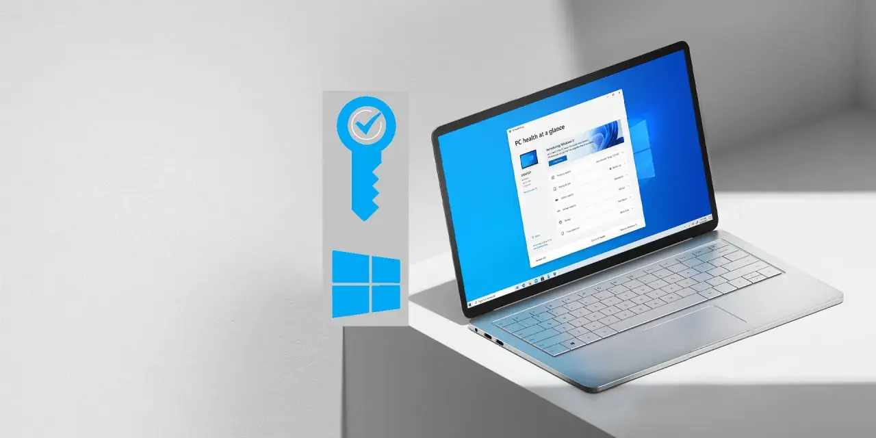 Grafika klucza z symbolem Windows i otwarty laptop z systemem Windows 11.