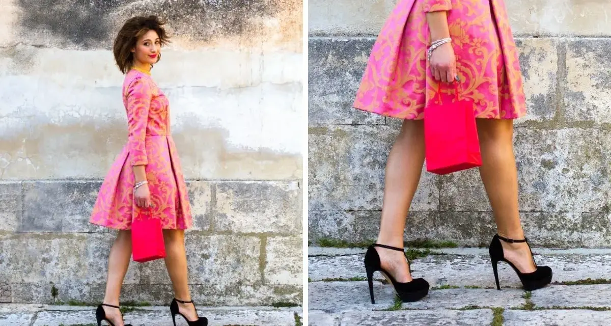 Elegancka stylizacja: jakie buty do różowej sukienki? Czarna, wysoka szpilka idealnie komponuje się z wzorzystą kreacją i torebką.