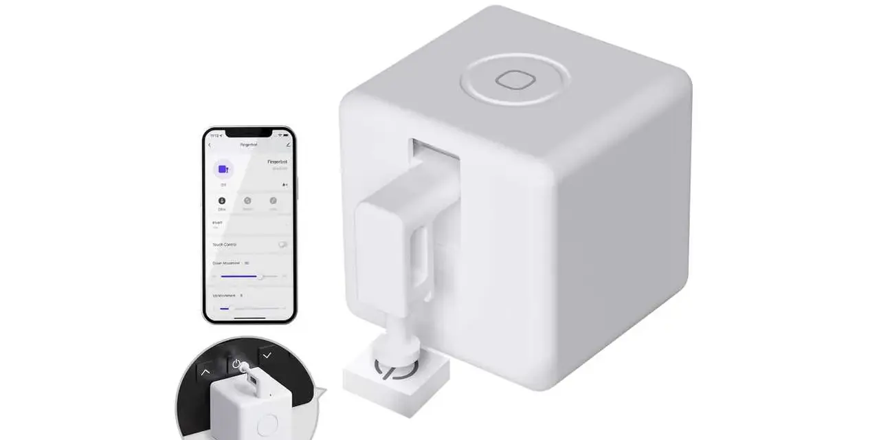 A white cube-shaped device with a robotic arm, paired with a smartphone app, showcasing cool IoT devices for smart home automation.