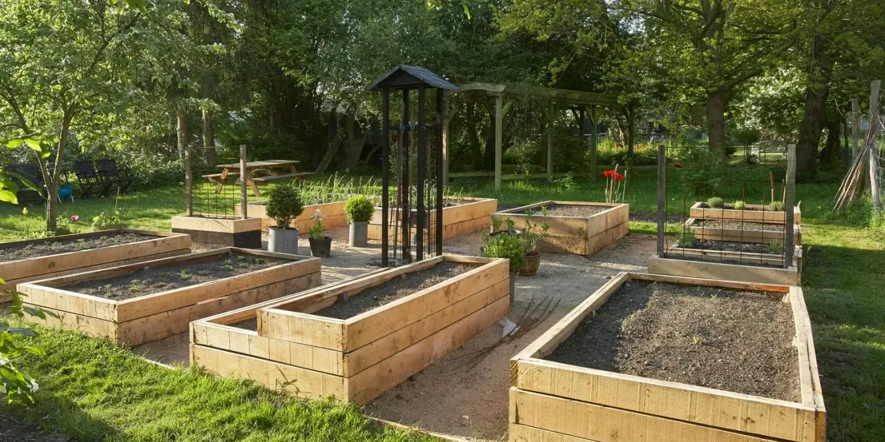 En vacker trädgård med flera nybyggda odlingslådor i trä, redo för plantering. En perfekt plats att bygga odlingslåda och njuta av sommaren.