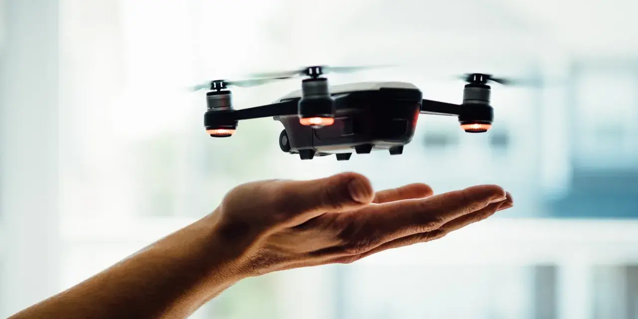 A drone hovers over an open hand, a visual metaphor for understanding Pennsylvania drone laws before takeoff.