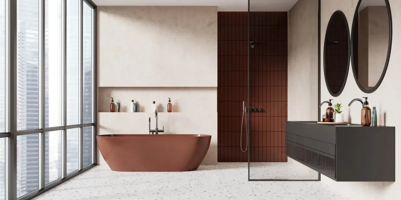 Salle de bain moderne avec baignoire rouille, douche en briques rouges et lavabo suspendu. Le sol en terrazzo offre une belle dimension carrelage.