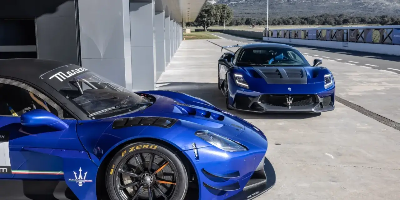Dwa niebieskie Maserati na torze wyścigowym. Jedno z nich, z bliska, ma na oponach napis Pirelli P Zero.