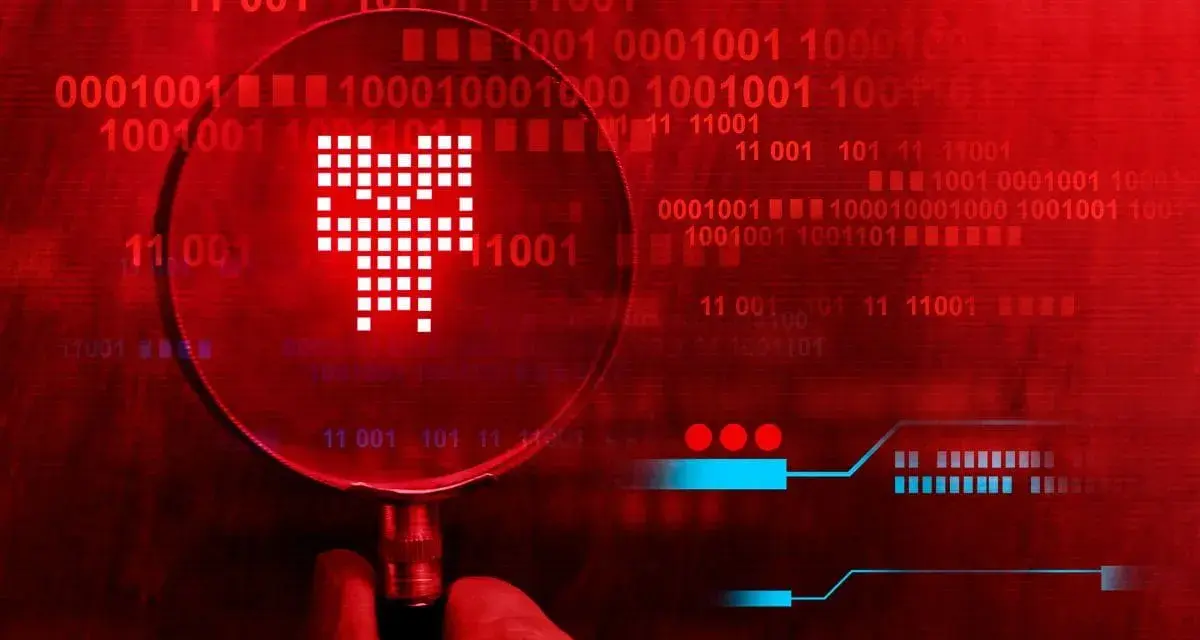 Pod lupą widać symbol przypominający czaszkę, symbolizujący **malware**. Tło to czerwony kod binarny, sugerujący zagrożenie cyfrowe.