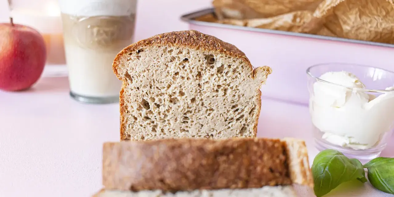 Frisches **Sandwichbrot** mit Butter, Milch und einem Apfel für ein leckeres Frühstück.