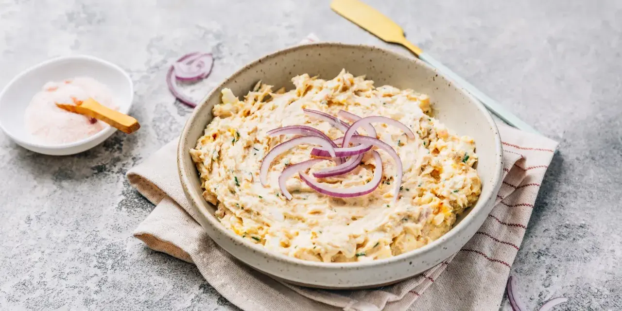 Pyszna pasta z tuńczyka i jajka, udekorowana krążkami czerwonej cebuli. Idealna na kanapki lub jako dodatek.