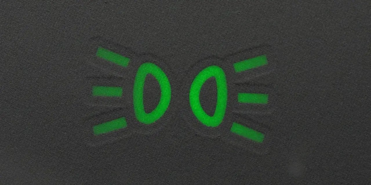 Zielony symbol świateł mijania na ciemnym tle.
