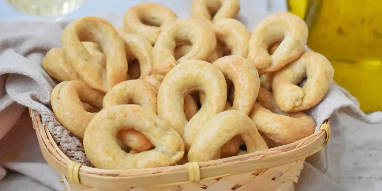 Koszyk pełen chrupiących taralli, idealnych do chrupania. Ten przepis na taralli to sekret włoskiej przekąski.