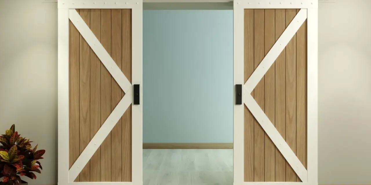 Two white-trimmed, wooden barn doors with black hardware slide open on a black track, showcasing a room beyond. This image illustrates how to install barn door hardware.