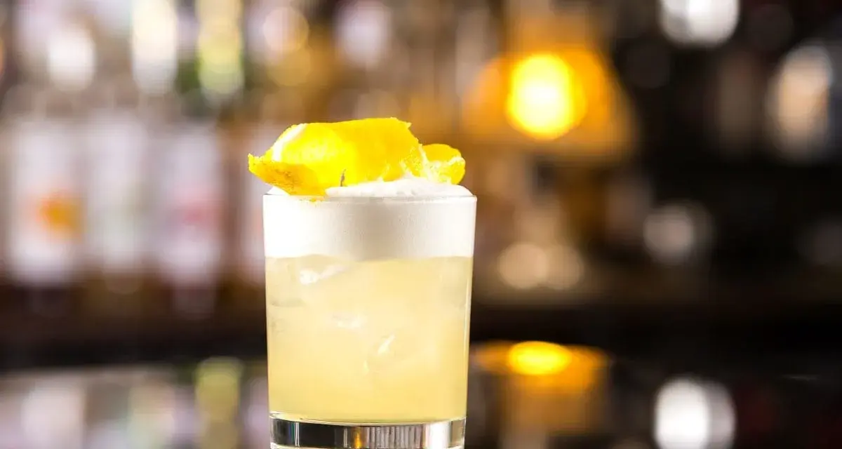 Klasyczny whisky sour przepis: orzeźwiający koktajl z pianką i skórką cytryny, idealny na każdą okazję.