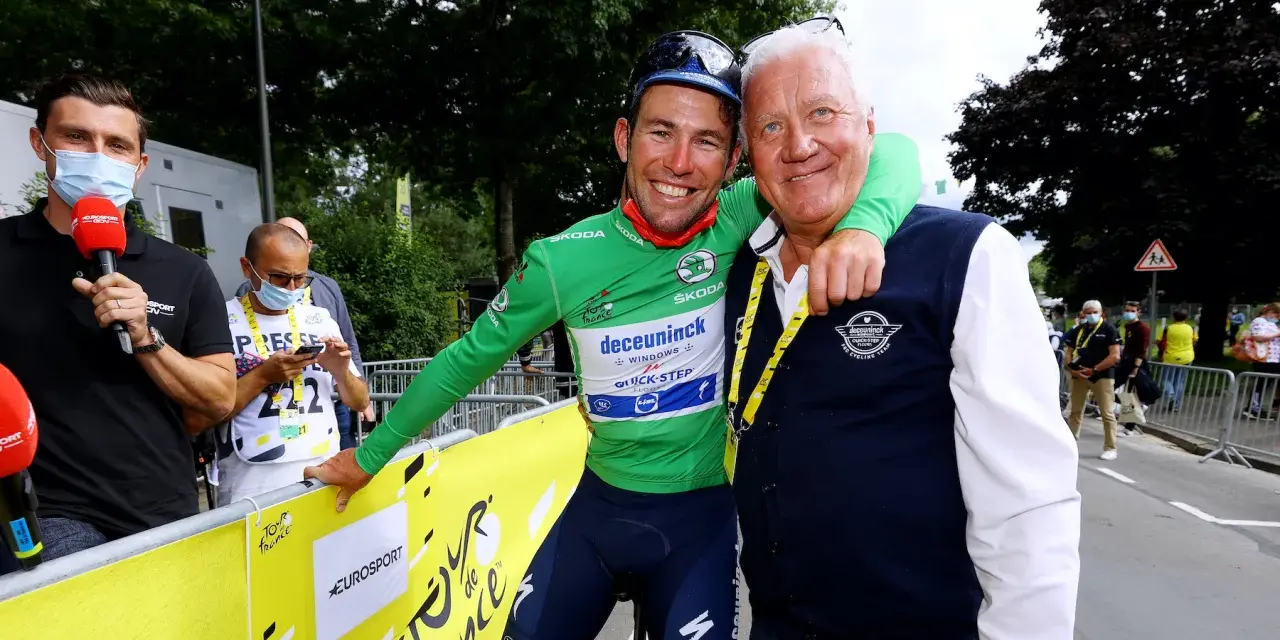 Cyclist in green jersey with Patrick Lefevere, both smiling.