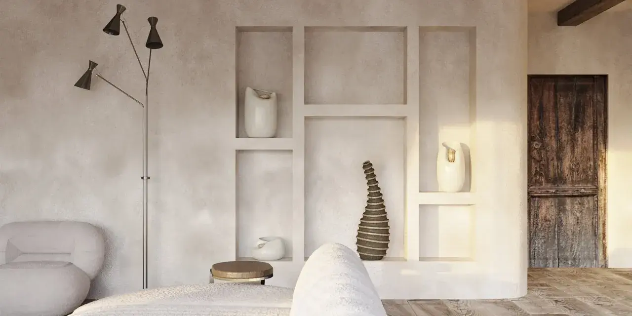 Wnętrze w stylu wabi sabi: surowe tynki, drewniane belki, rustykalne drzwi i minimalistyczne dekoracje tworzą spokojną atmosferę.