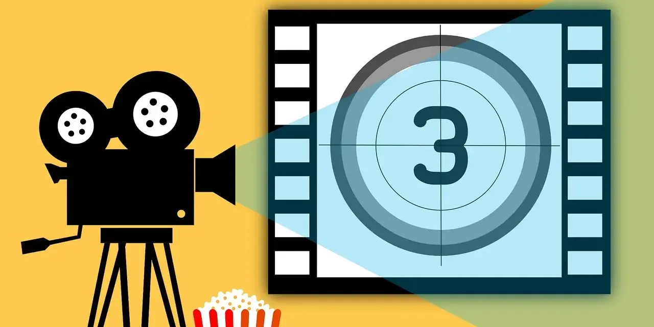 Kamera filmowa, popcorn i plansza z cyfrą 3 – idealne na wieczór z filmami o fotografii.