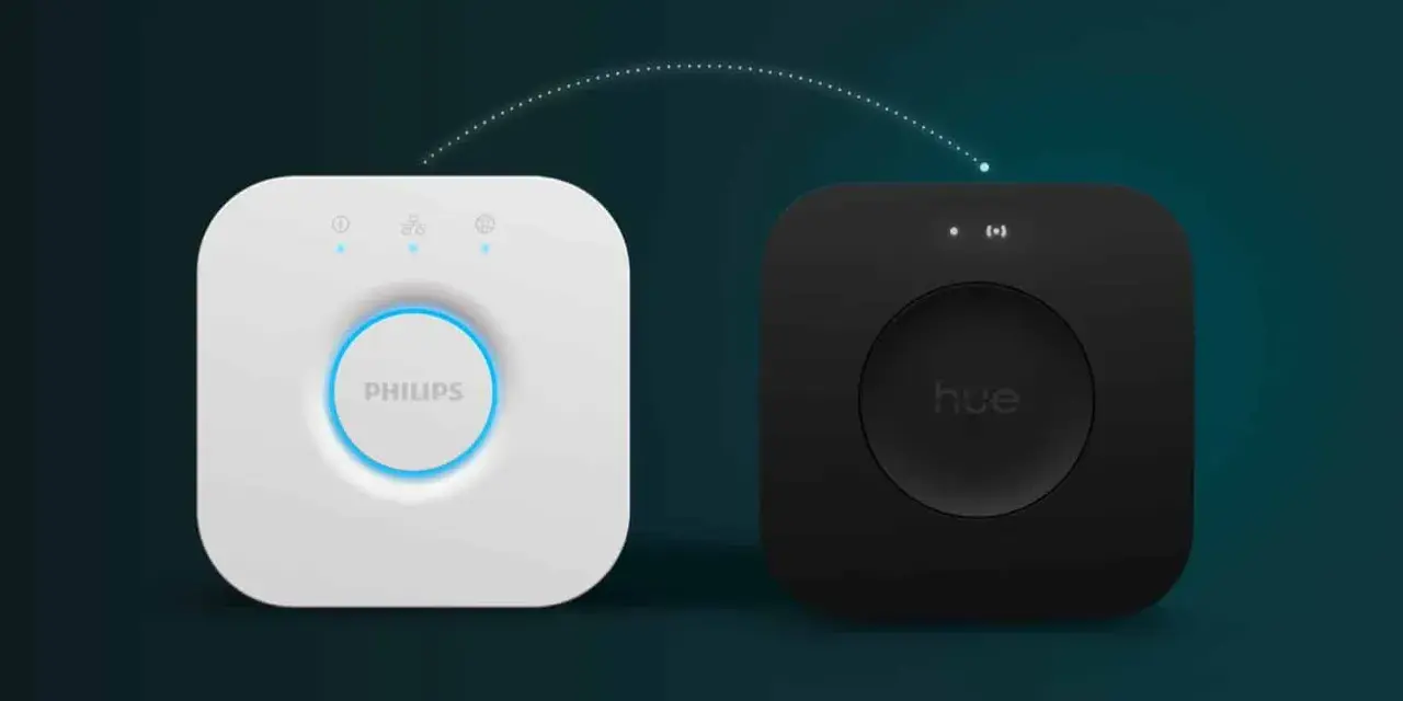 Zwei Hue Bridges, weiß und schwarz, verbunden durch eine gestrichelte Linie. So verbinden Sie Ihre Hue Bridge mit neuem WLAN.