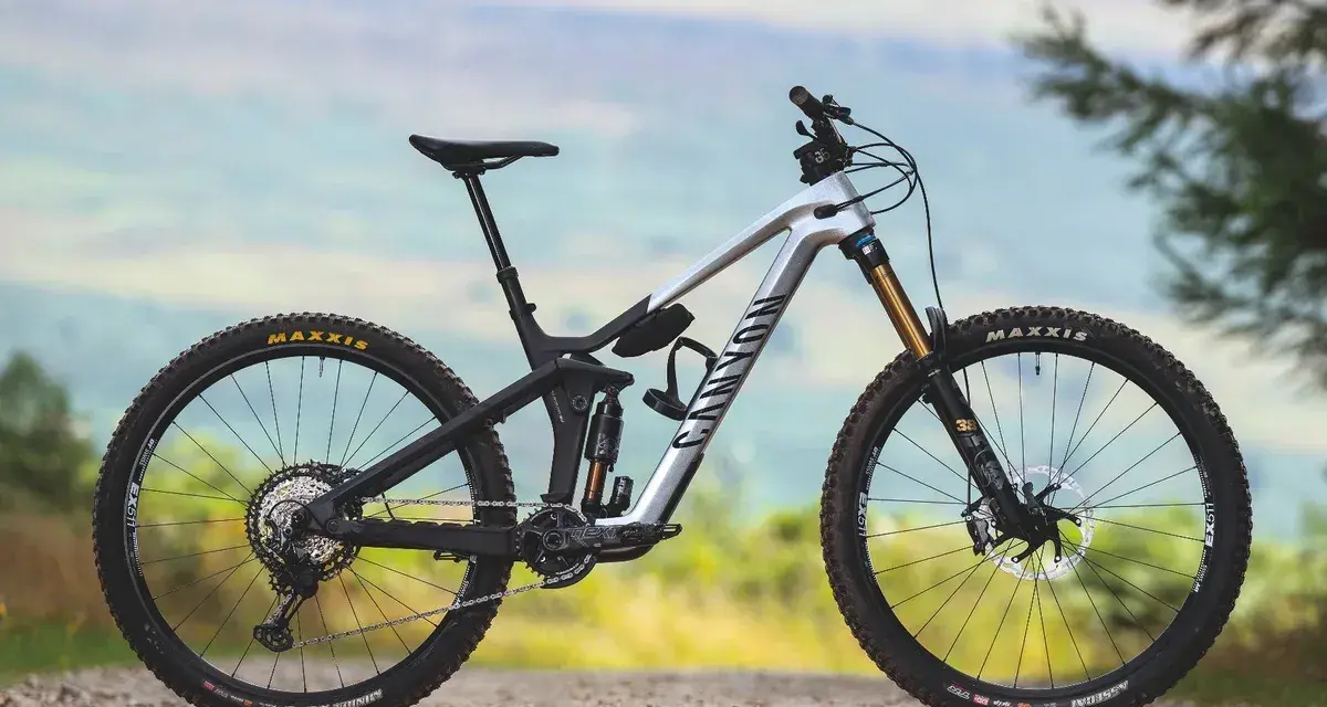 A silver Canyon enduro mountain bike with full suspension, ready to tackle any trail.