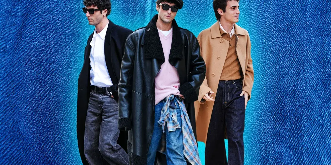 Tre uomini con un outfit elegante con jeans. Uno indossa un cappotto nero, camicia bianca e jeans grigi. Un altro un cappotto in pelle nero, maglione rosa e jeans blu. Il terzo un cappotto cammello, maglione marrone e jeans scuri.
