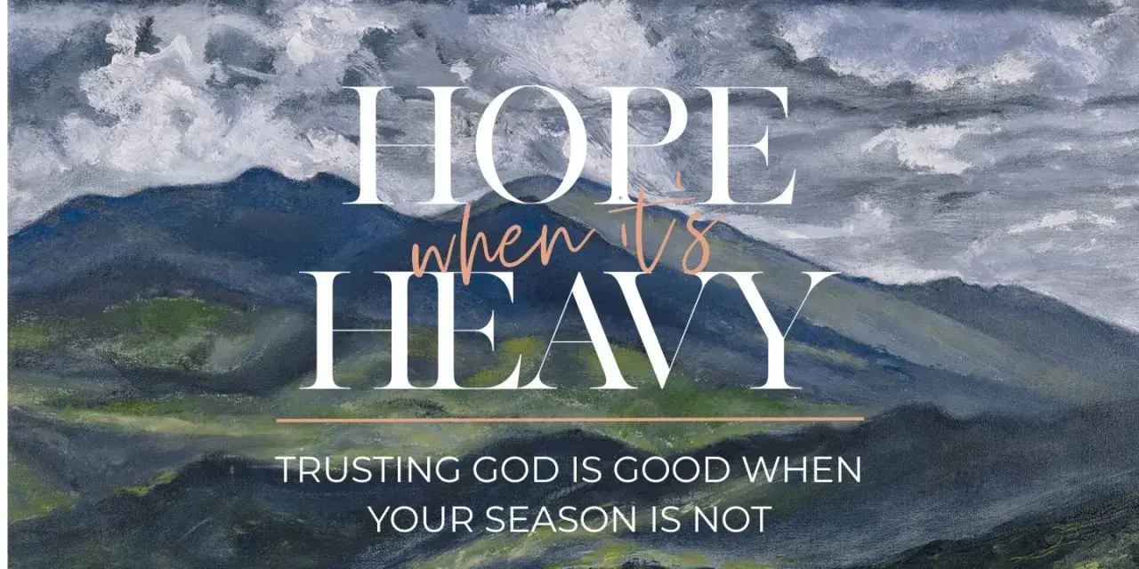 Hope when it's heavy. Trusting God is good when your season is not. A painted mountain landscape under stormy skies.