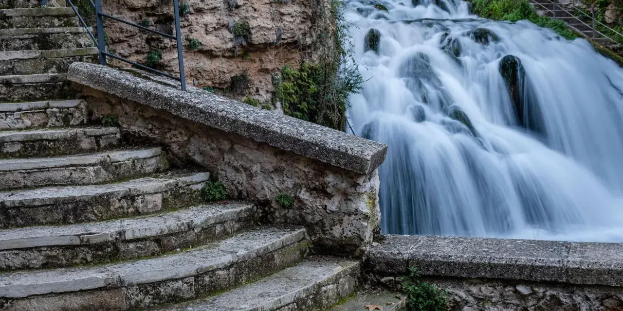 Escaleras de piedra desgastada conducen a las impresionantes trillo cascadas, con agua blanca cayendo en cascada sobre rocas cubiertas de musgo.