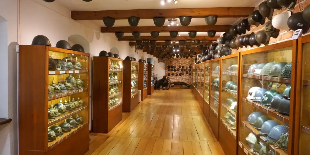 W muzeum militariów we Wrocławiu można podziwiać imponującą kolekcję hełmów z różnych epok, wyeksponowanych w gablotach i na drewnianych belkach.