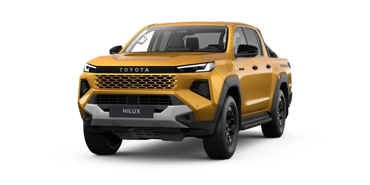 Złoty Toyota Hilux, nowy model pickup, z charakterystycznym grillem i nowoczesnymi światłami. Gotowy na każdą przygodę.