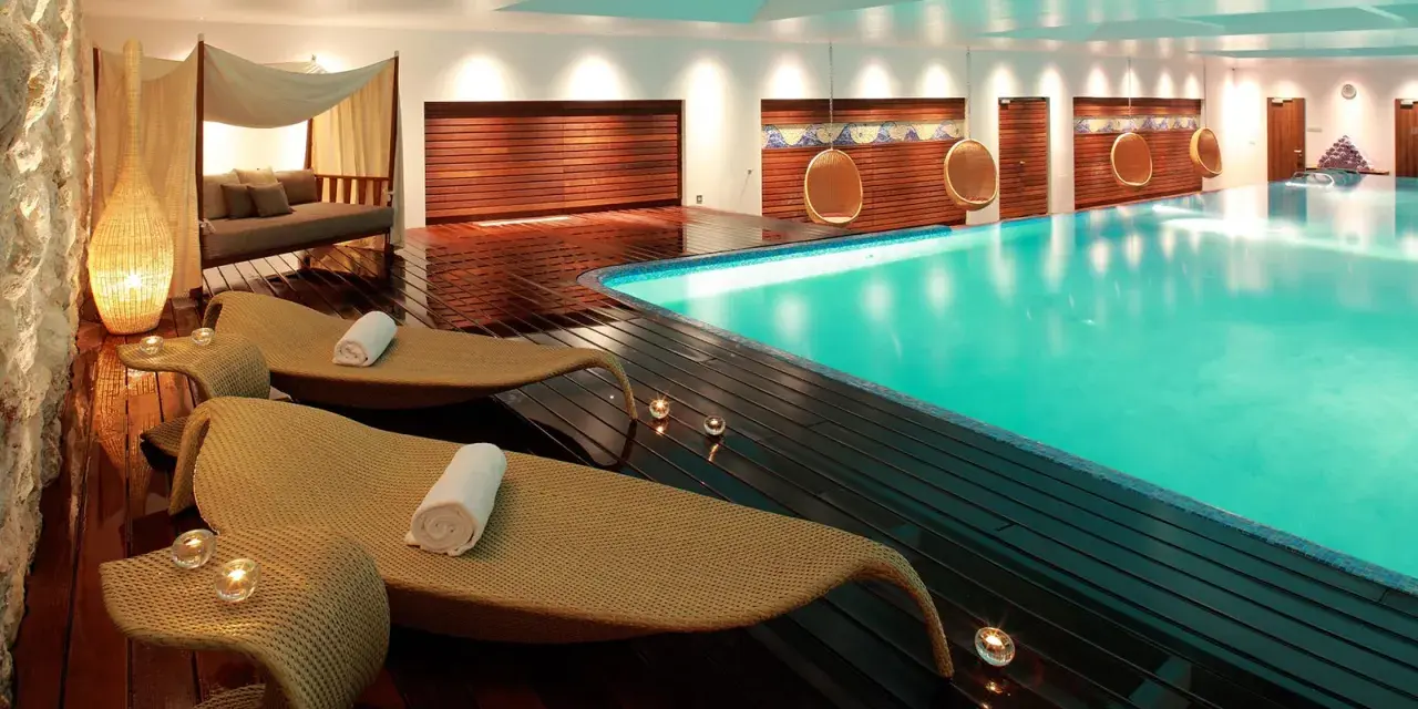 Rilassati in questa spa: piscina turchese, lettini comodi, candele e un'atmosfera di pace. Ecco cosa si fa in una spa per rigenerarsi.