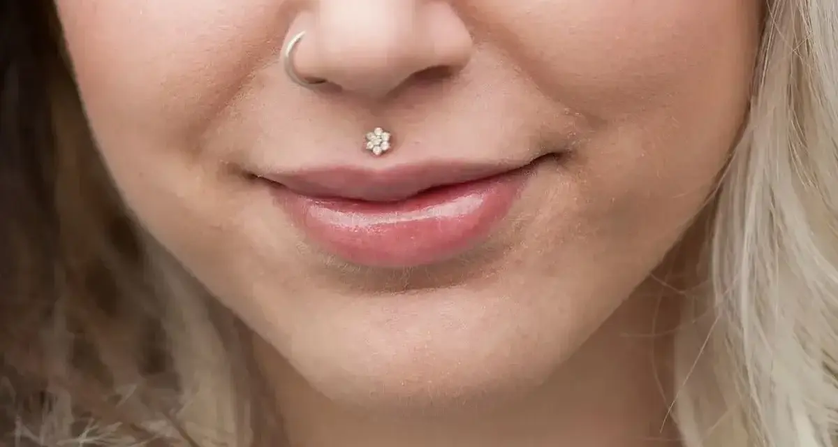 Delikatny piercing ust w kształcie kwiatka, ozdoba twarzy. Dowiedz się, co to piercing i jak podkreśla urodę.