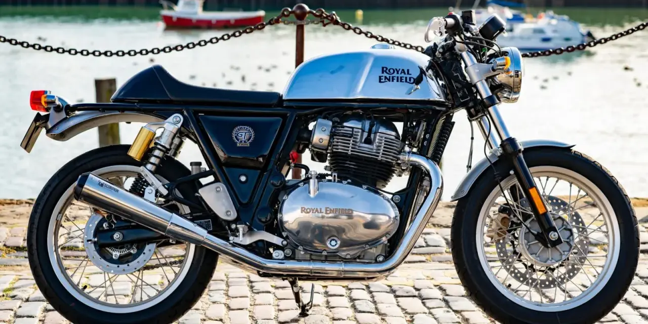 Błyszczący, chromowany rozrząd królewski Royal Enfield Continental GT 650 na tle portu.
