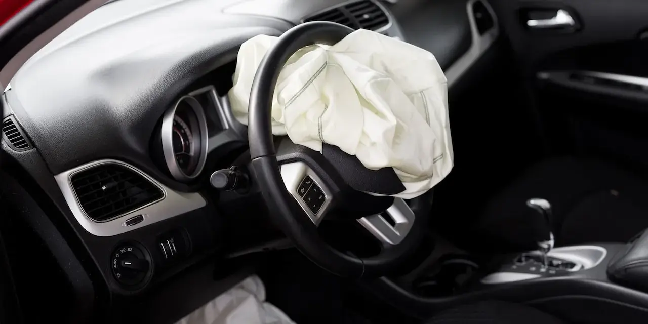 The driver's side airbag has deployed. This image raises the question: can airbags be replaced after an accident?