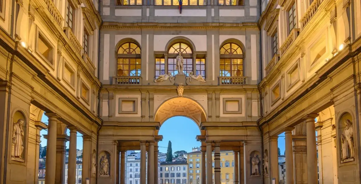 The Uffizi Gallery's courtyard at dusk, with its grand architecture and statues, offers a glimpse of Florence's artistic heritage, rivaling the Accademia.