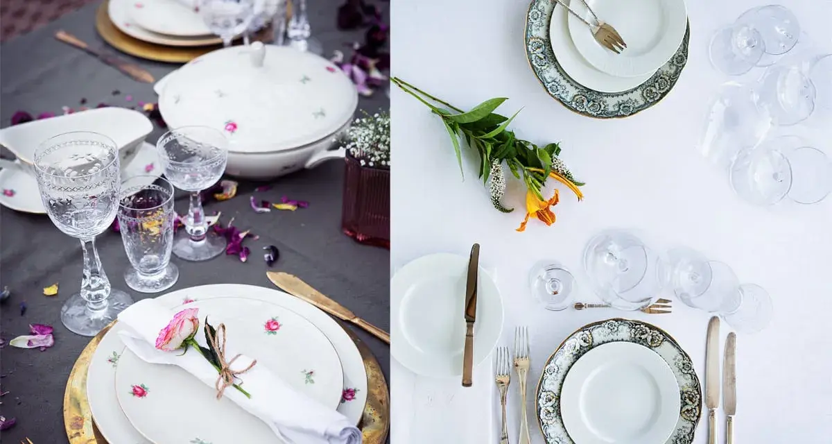 Vackert dukat bord med vita rosa tallrikar, glas och blommor. En romantisk middagsbjudning väntar.