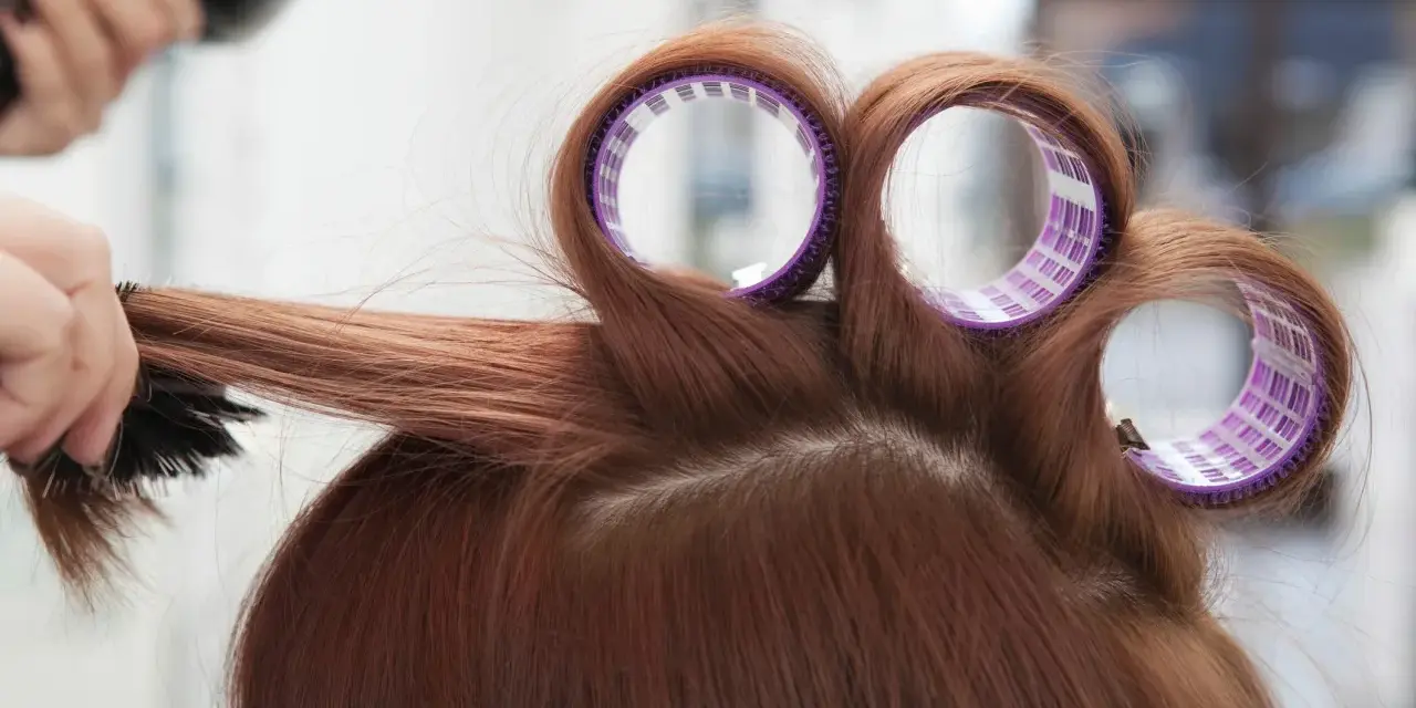 Profesjonalne styling włosów: lokówka i szczotka tworzą objętość.