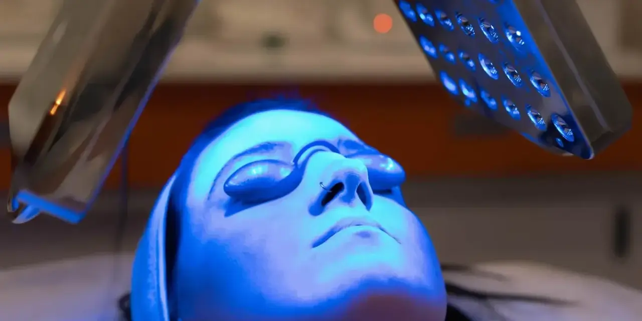 Woman receiving blue light therapy, exploring the blue light benefits for skin.