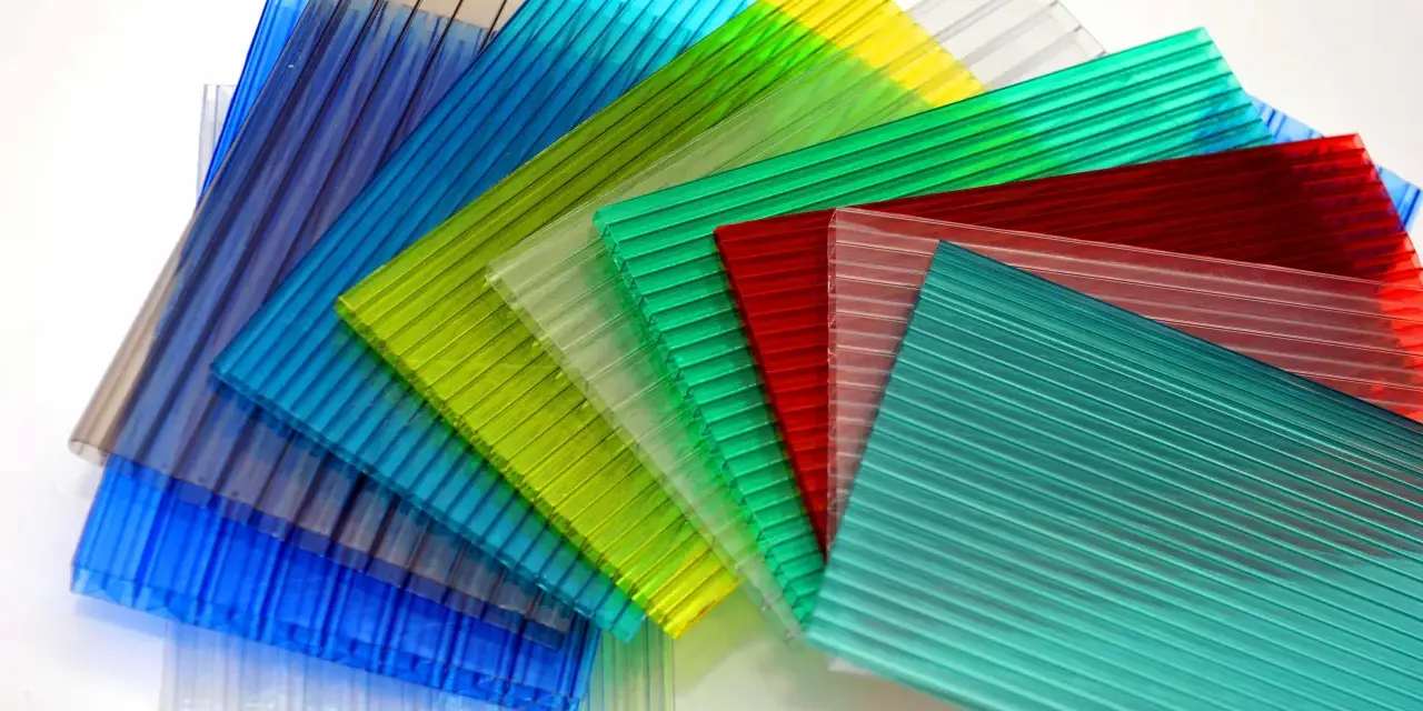 Sheets of colorful, ribbed polycarbonate, showcasing their versatility and potential for polycarbonate sustainability in various applications.