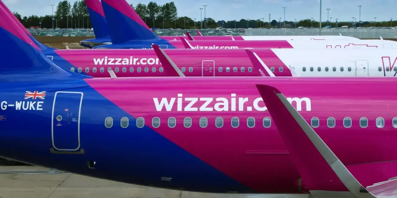 Rząd różowych samolotów Wizzair na płycie lotniska. Może to być widok przed lub po zwrocie biletu Wizzair.