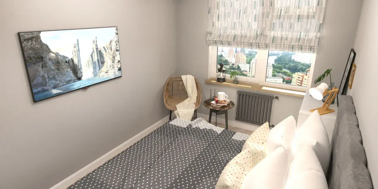 Acogedora habitación pequeña con cama, TV en la pared y ventana con vistas a la ciudad.