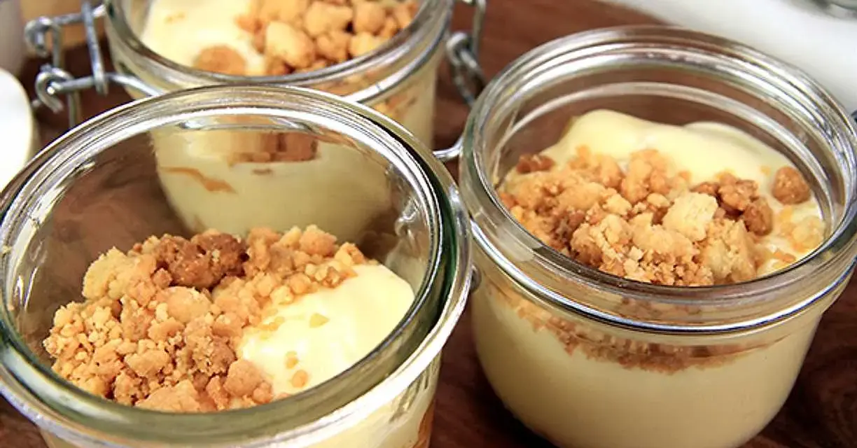 Tre små glasburkar med len vit chokladmousse toppad med smulig crumble. Perfekt för en söt stund.