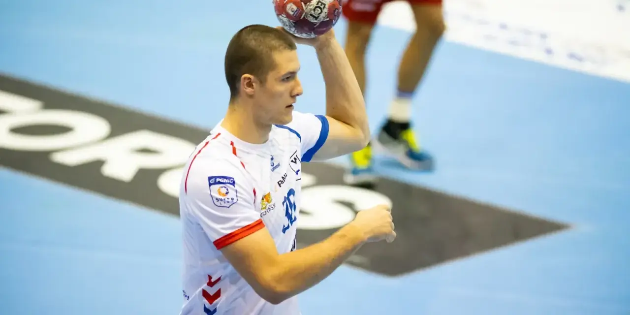 Wiktor Tomczak, zawodnik piłki ręcznej, przygotowuje się do rzutu.