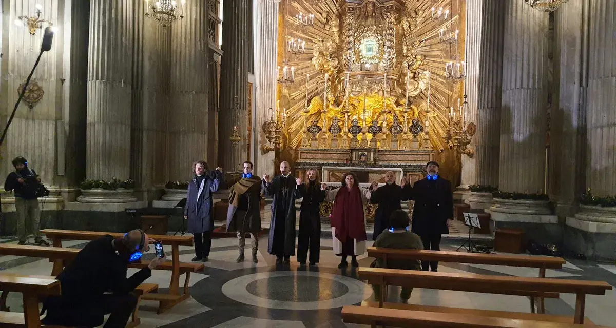 A group of people in a church, some holding hands, with a large golden altar in the background.
