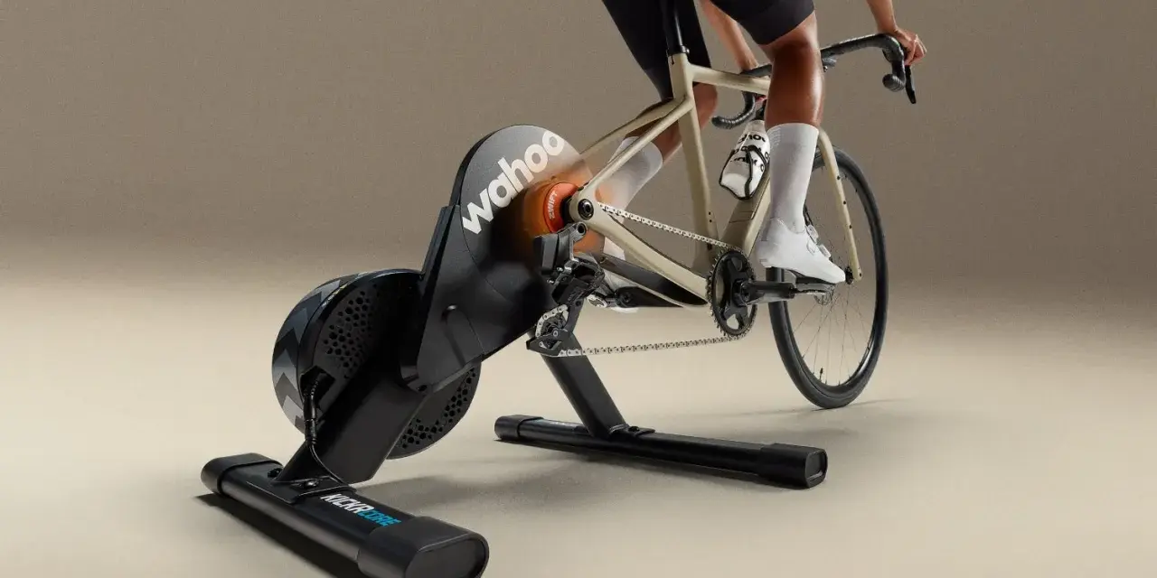 A cyclist rides indoors on a Wahoo Kickr Core 2 trainer, simulating an outdoor ride with realistic resistance.