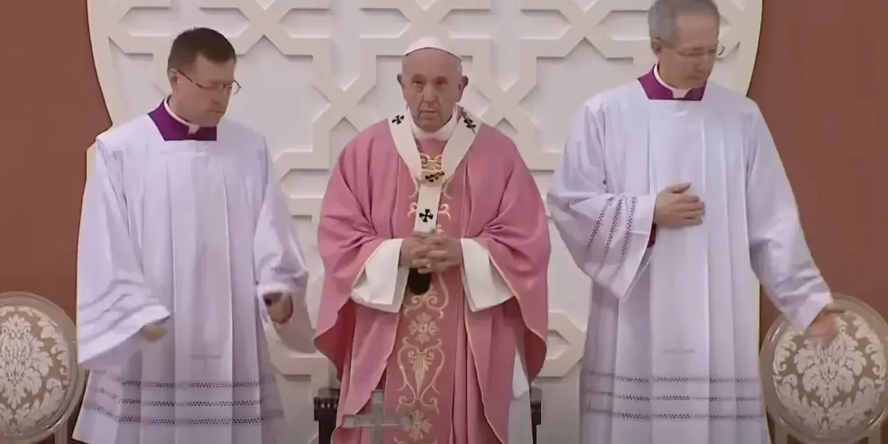 Pope Francis, in a pink vestment for the fourth Sunday of Lent, stands between two clergy members in white albs.