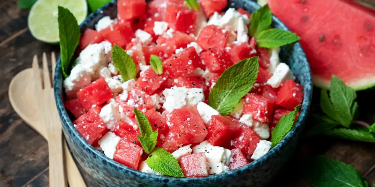 Erfrischender Wassermelone Feta Salat mit Minze und Limette, garniert mit schwarzem Pfeffer. Perfekt für heiße Tage.