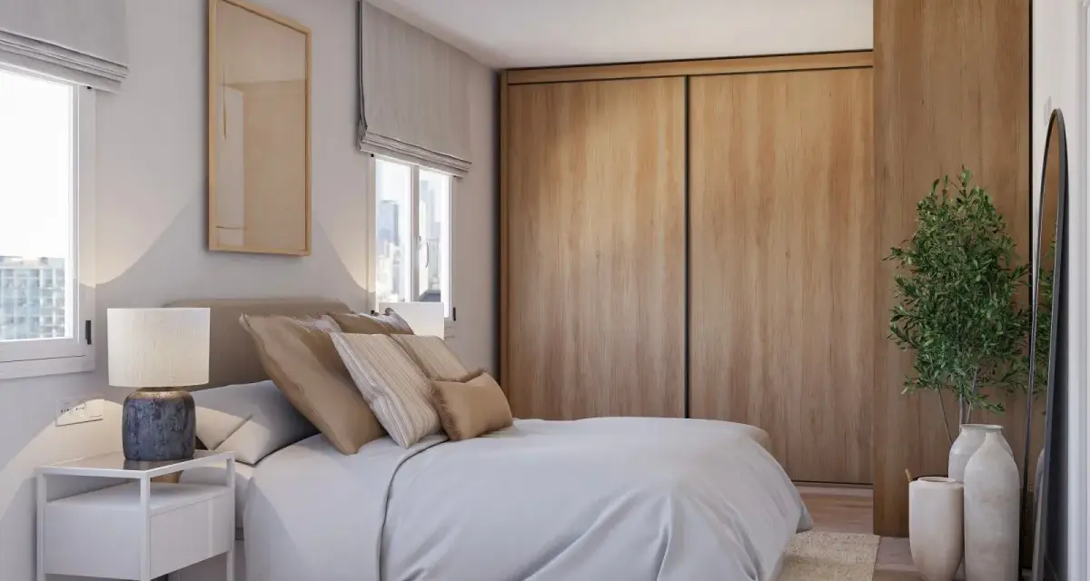 Acogedor dormitorio estilo escandinavo con cama, mesita de noche, armario de madera y planta decorativa.
