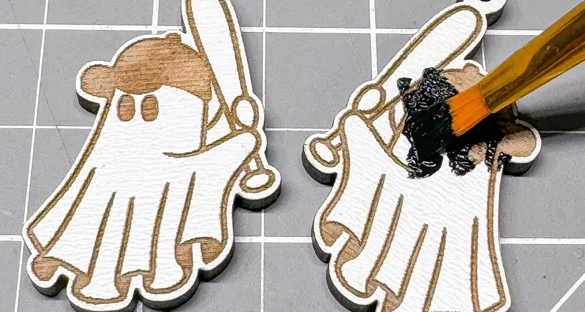 Painting a laser-engraved ghost with a baseball bat black. This shows how to color laser engraving for a spooky effect.