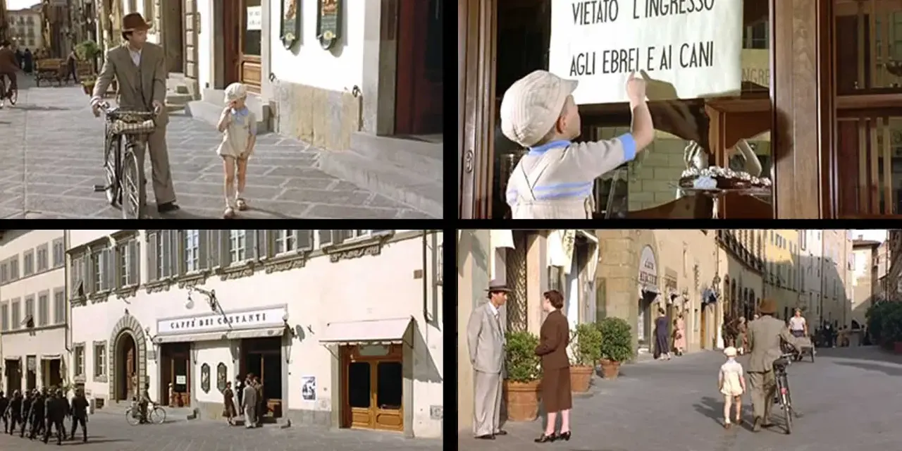 Scena di film girati ad Arezzo: un bambino legge un cartello "Vietato l'ingresso agli ebrei e ai cani", un padre e figlio passeggiano, un caffè storico e una strada con persone.