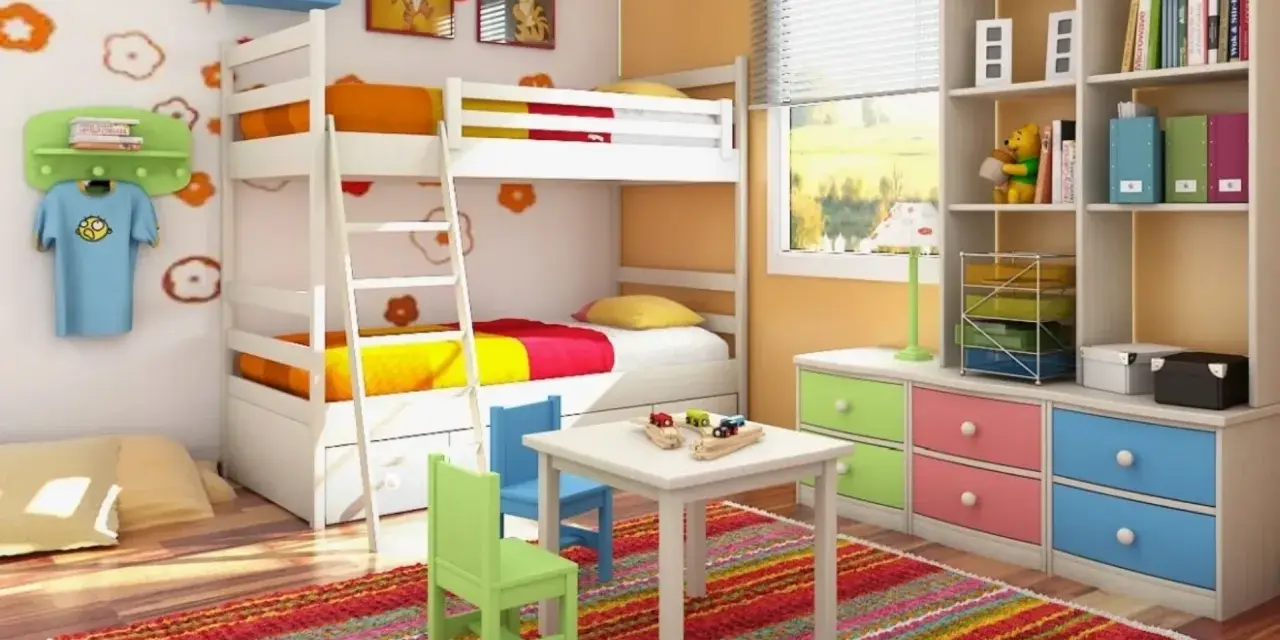 Cameretta bambino 6 anni con letto a castello, scrivania, tappeto colorato e libreria piena di giochi e libri.