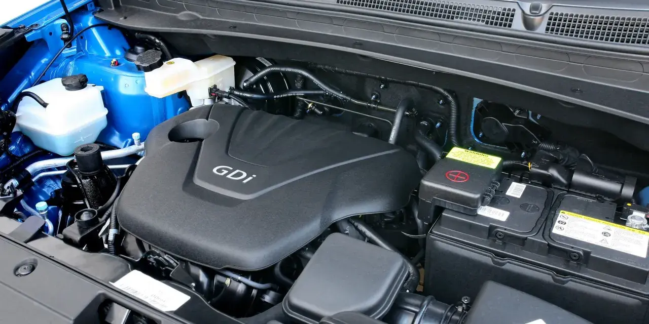 Silnik GDI w Kia Sportage (2015) z widocznym akumulatorem i płynami.