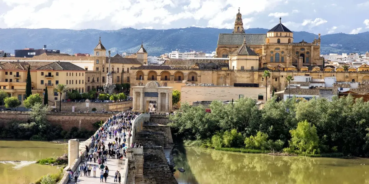 A bustling Roman bridge leads to the historic Mezquita-Cathedral of Córdoba. This view makes you wonder how many days in Córdoba are enough to explore its wonders.