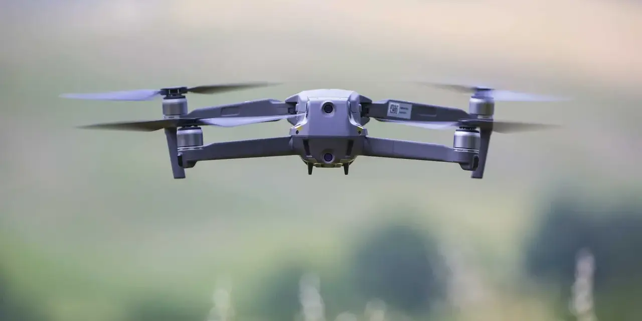 A drone hovers mid-air, its propellers blurred with motion. Planning to fly one in the Dominican Republic? Be sure to check the Dominican Republic drone laws first.