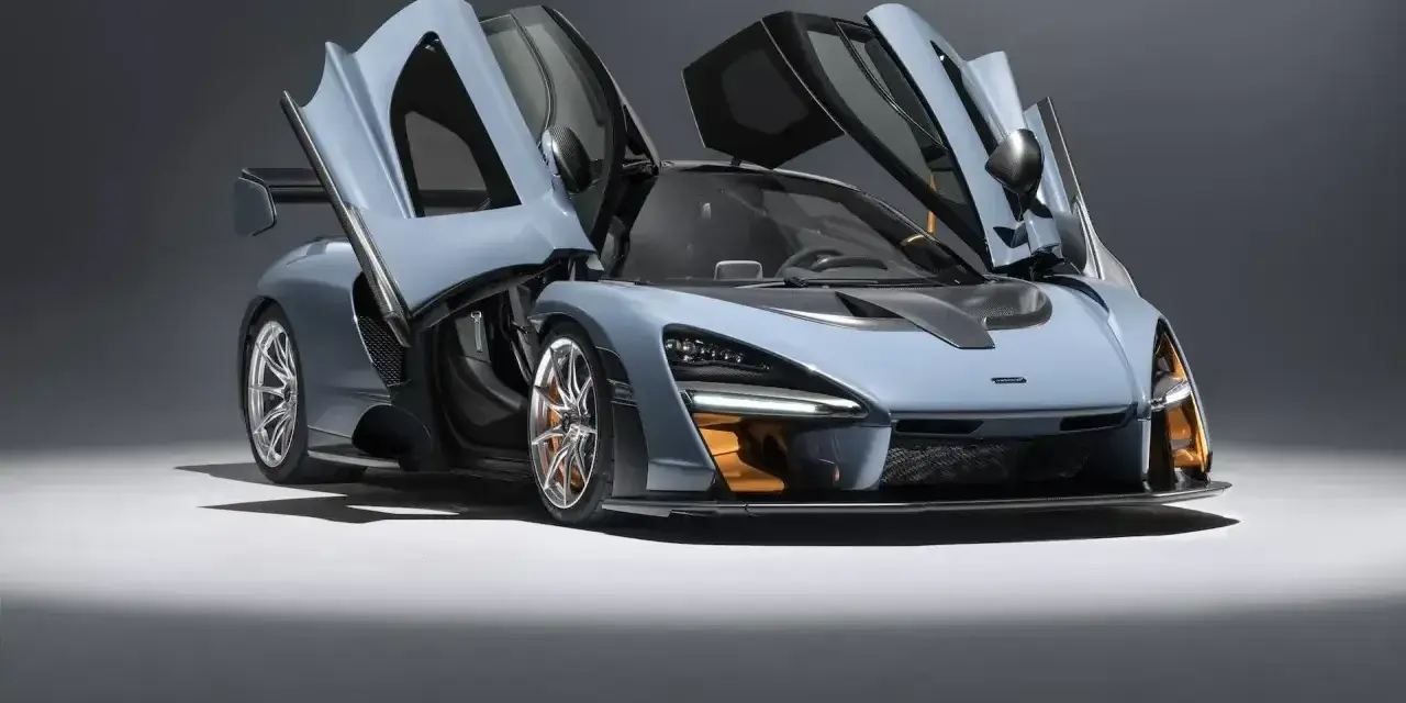 Niebieski McLaren Senna z otwartymi drzwiami, gotowy do startu.