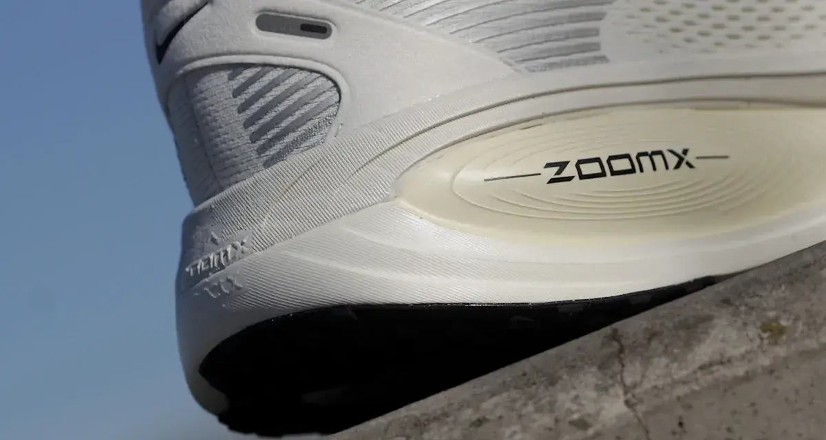 Biały but sportowy z technologią ZoomX. Drop w butach to różnica wysokości między piętą a palcami, kluczowa dla komfortu biegania.